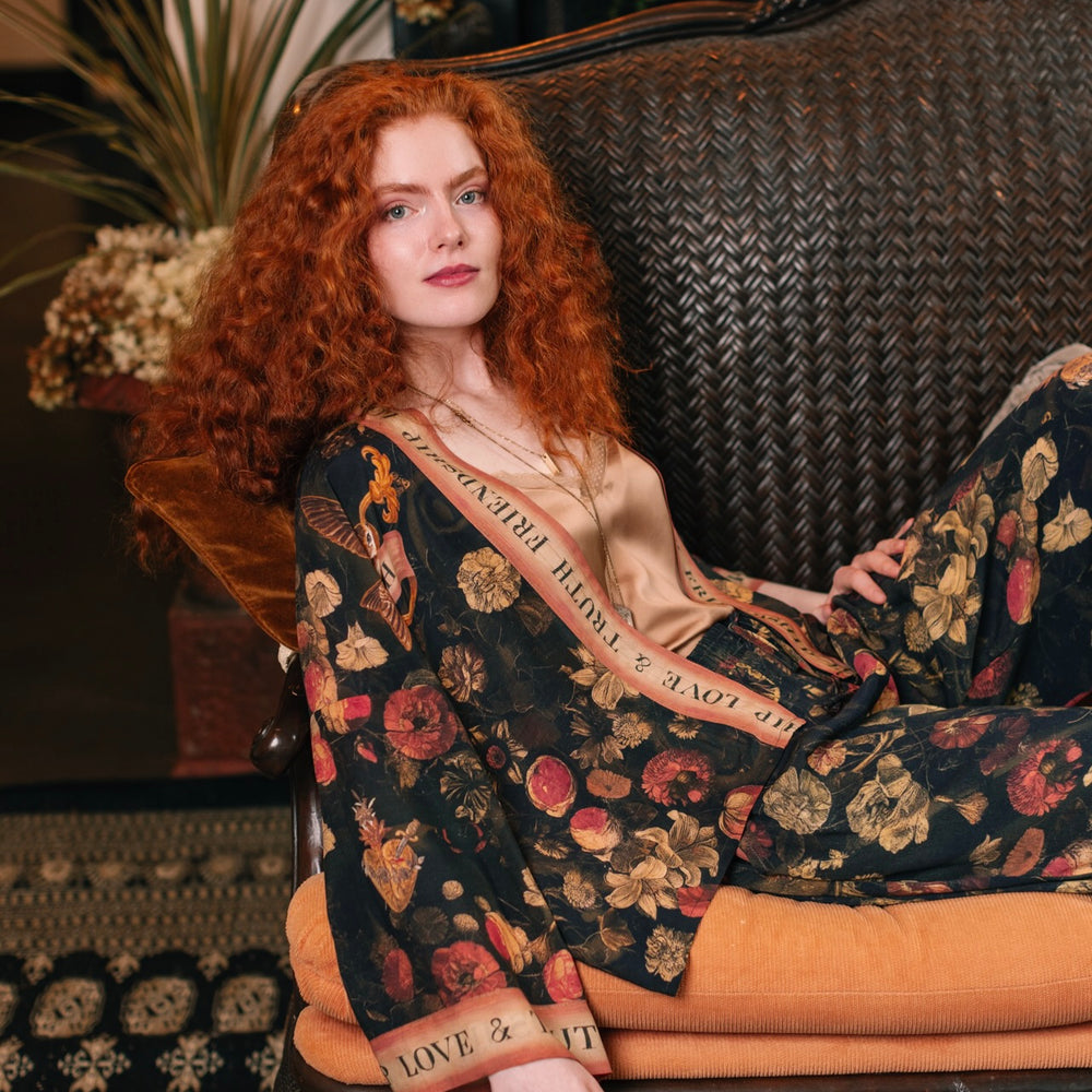 
                  
                    Model wearing a cropped-length bamboo-viscose duster featuring a collage of antique artwork with romance, loyalty, and old-world beauty - Market of Stars
                  
                