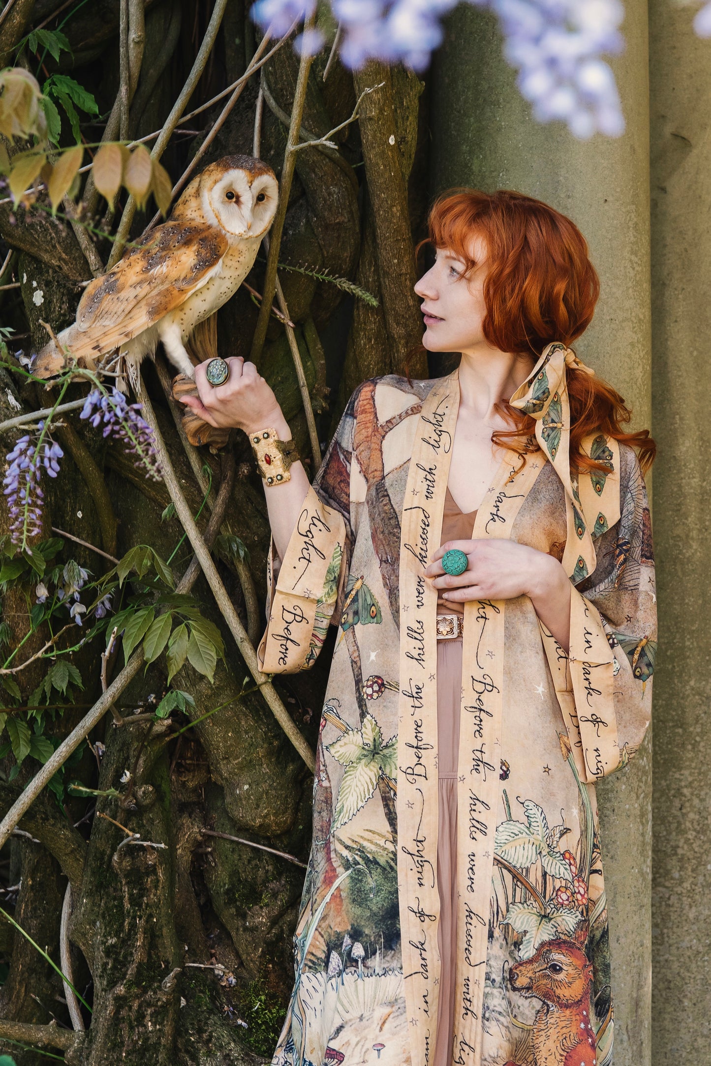 Model wearing an enchanting kimono duster robe featuring illustrations by Charles van Sandwyck's, crafted from airy bamboo-based viscose with a touch of whimsical magic - Market of Stars