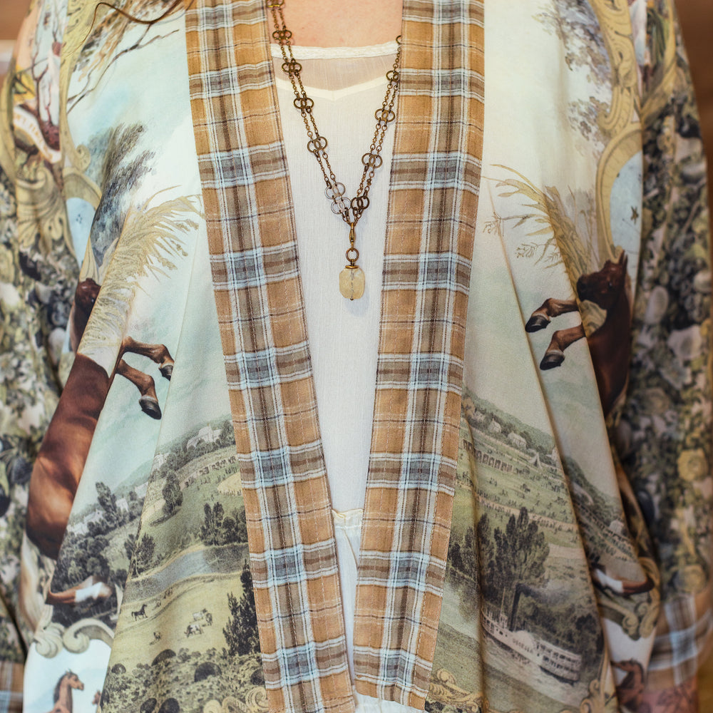 
                  
                    Model wearing a bamboo-viscose cropped kimono duster made for everyday adventures with a whimsical print celebrating one's unbridled spirit of adventure - Market of Stars
                  
                