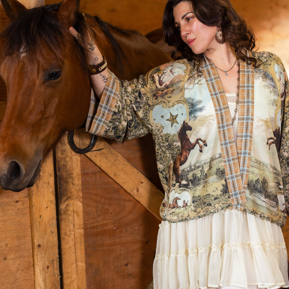 
                  
                    Model wearing a bamboo-viscose cropped kimono duster made for everyday adventures with a whimsical print celebrating one's unbridled spirit of adventure - Market of Stars
                  
                