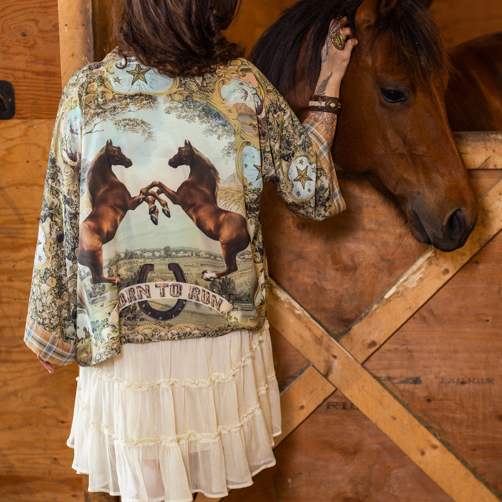 Model wearing a bamboo-viscose cropped kimono duster made for everyday adventures with a whimsical print celebrating one's unbridled spirit of adventure - Market of Stars