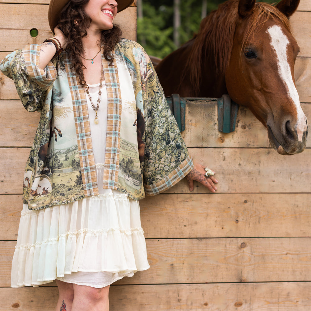 
                  
                    Model wearing a bamboo-viscose cropped kimono duster made for everyday adventures with a whimsical print celebrating one's unbridled spirit of adventure - Market of Stars
                  
                