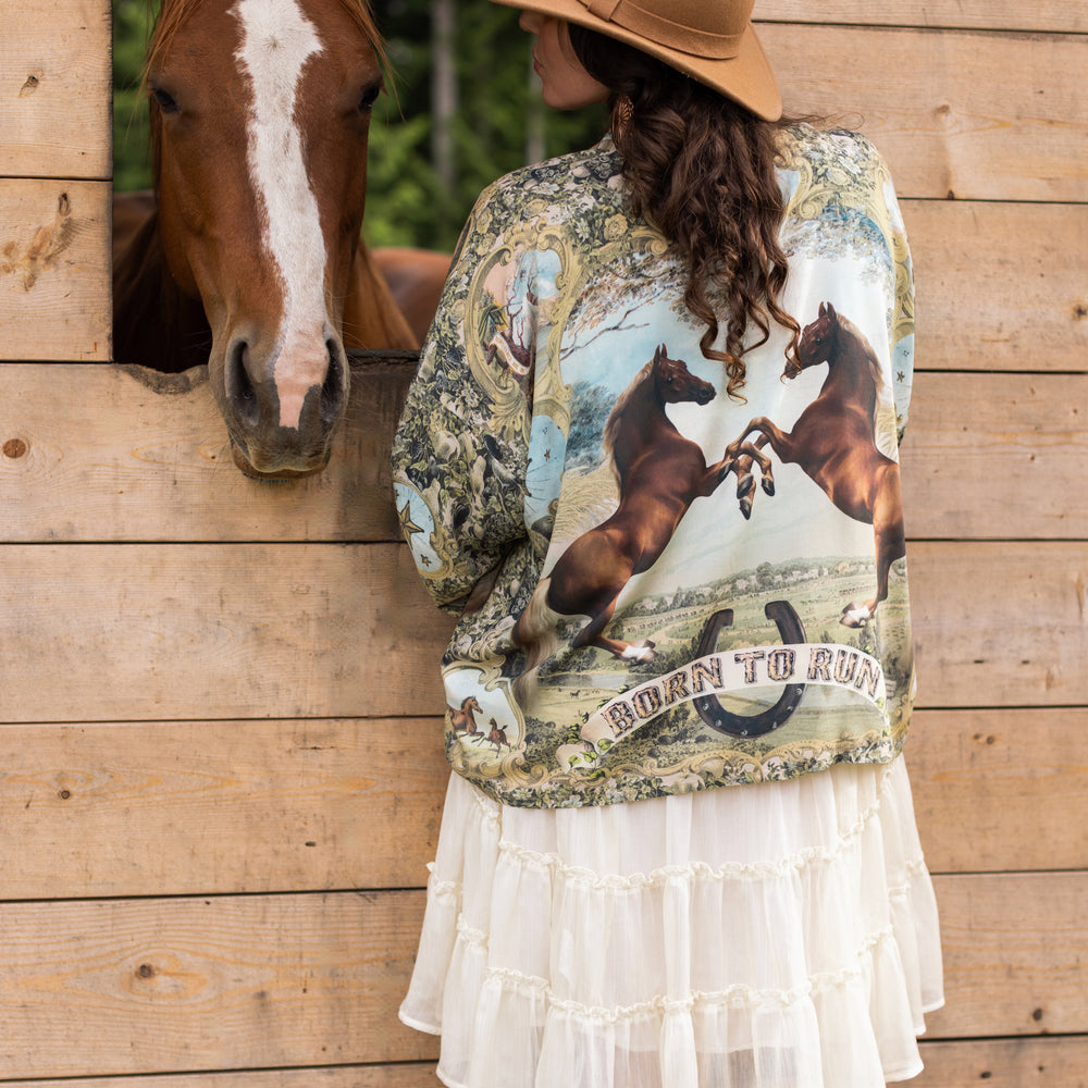 
                  
                    Model wearing a bamboo-viscose cropped kimono duster made for everyday adventures with a whimsical print celebrating one's unbridled spirit of adventure - Market of Stars
                  
                