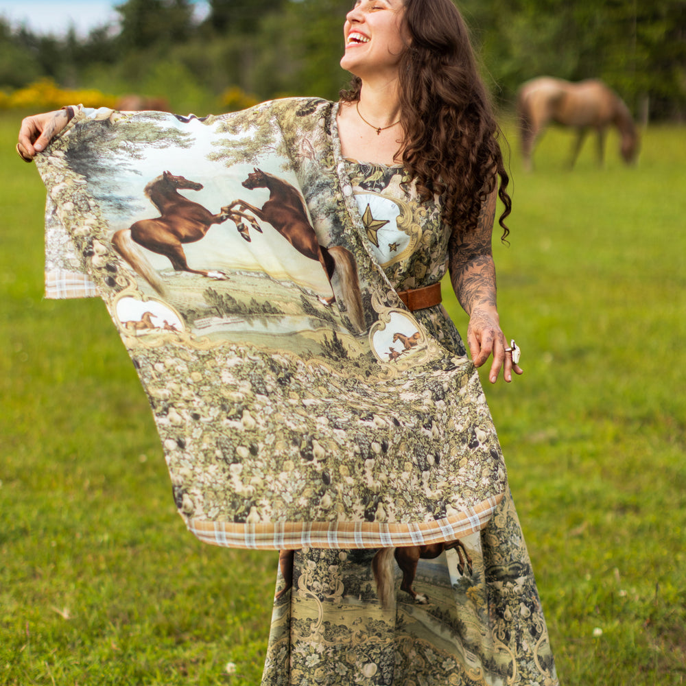 
                  
                    Model wearing a bamboo-viscose scarf made for everyday adventures with a whimsical print celebrating one's unbridled spirit of adventure - Market of Stars
                  
                