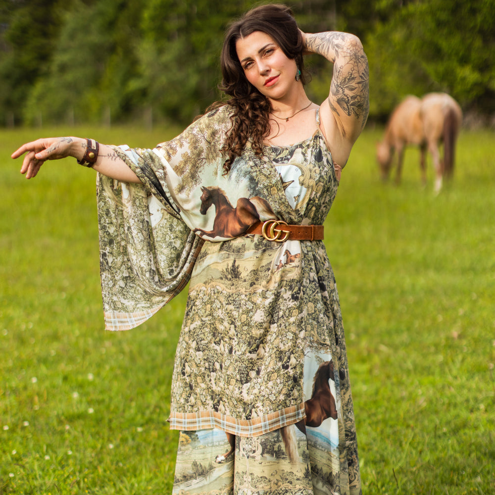 
                  
                    Model wearing a bamboo-viscose scarf made for everyday adventures with a whimsical print celebrating one's unbridled spirit of adventure - Market of Stars
                  
                
