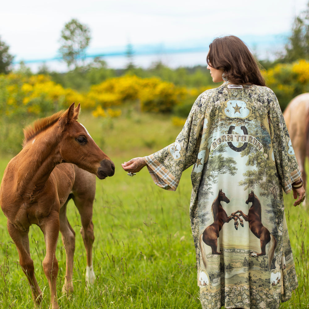 
                  
                    Model wearing a bamboo-viscose kimono duster robe made for everyday adventures with a whimsical print celebrating one's unbridled spirit of adventure - Market of Stars
                  
                