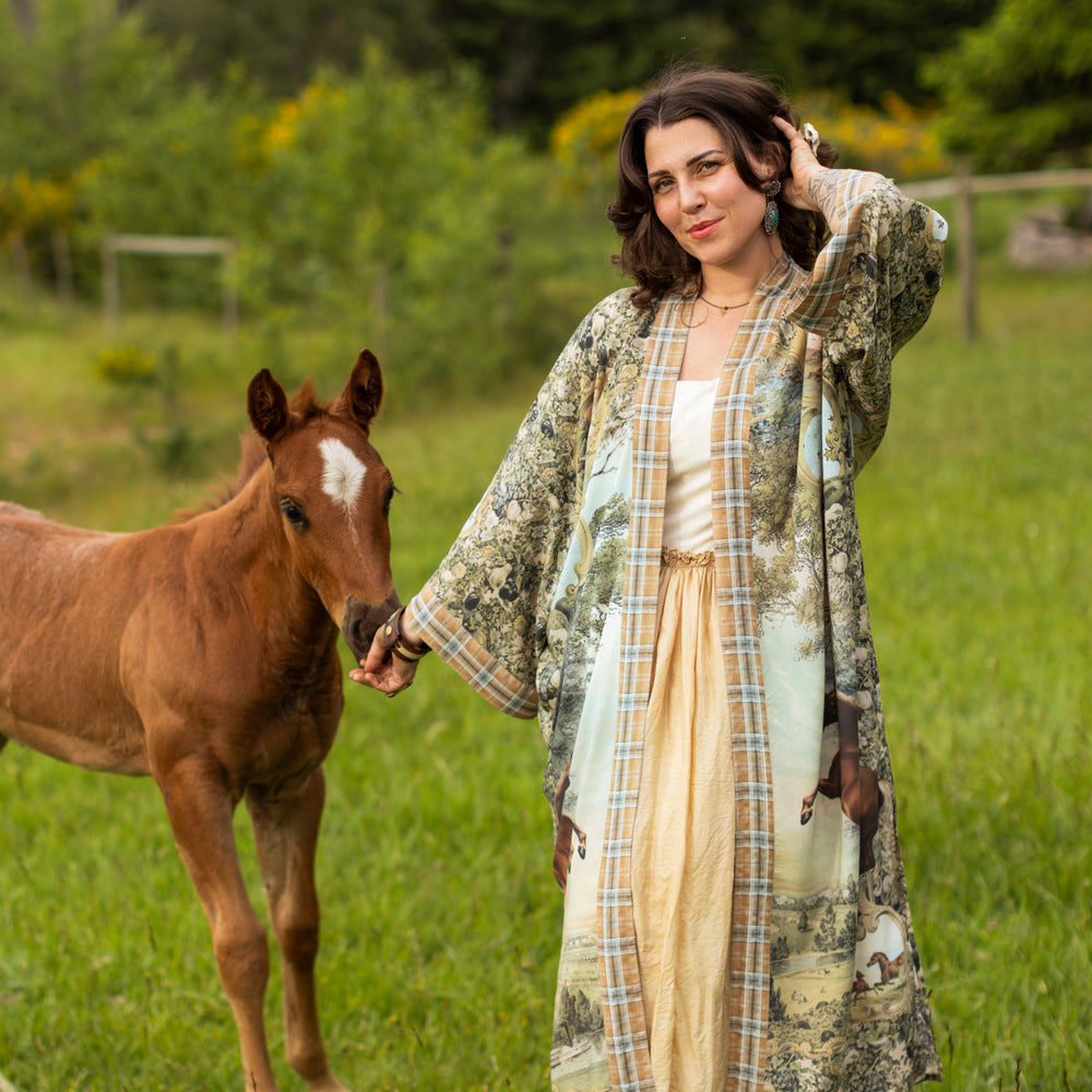 
                  
                    Model wearing a bamboo-viscose kimono duster robe made for everyday adventures with a whimsical print celebrating one's unbridled spirit of adventure - Market of Stars
                  
                