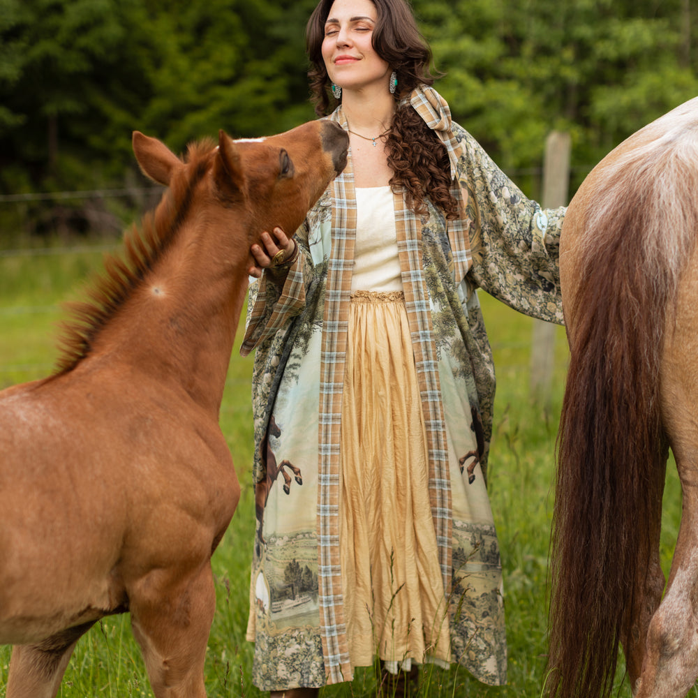 
                  
                    Model wearing a bamboo-viscose kimono duster robe made for everyday adventures with a whimsical print celebrating one's unbridled spirit of adventure - Market of Stars
                  
                