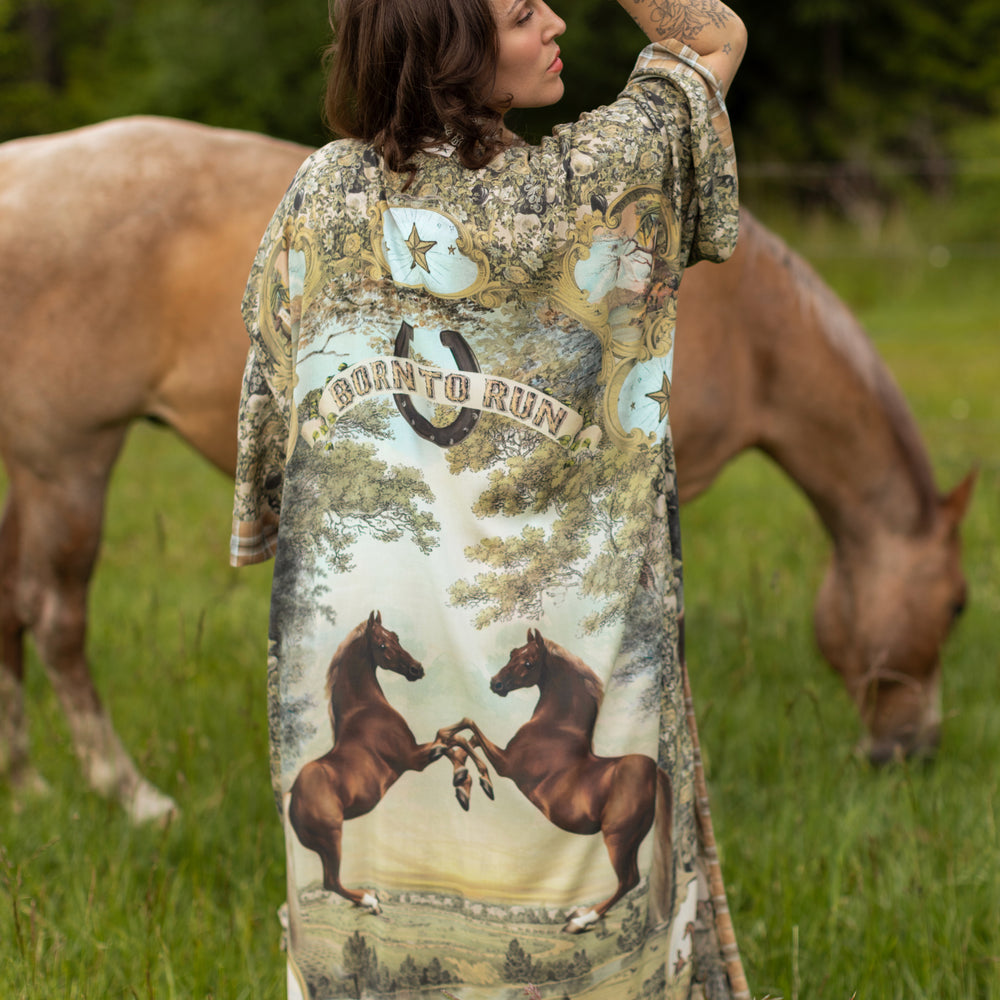 
                  
                    Model wearing a bamboo-viscose kimono duster robe made for everyday adventures with a whimsical print celebrating one's unbridled spirit of adventure - Market of Stars
                  
                
