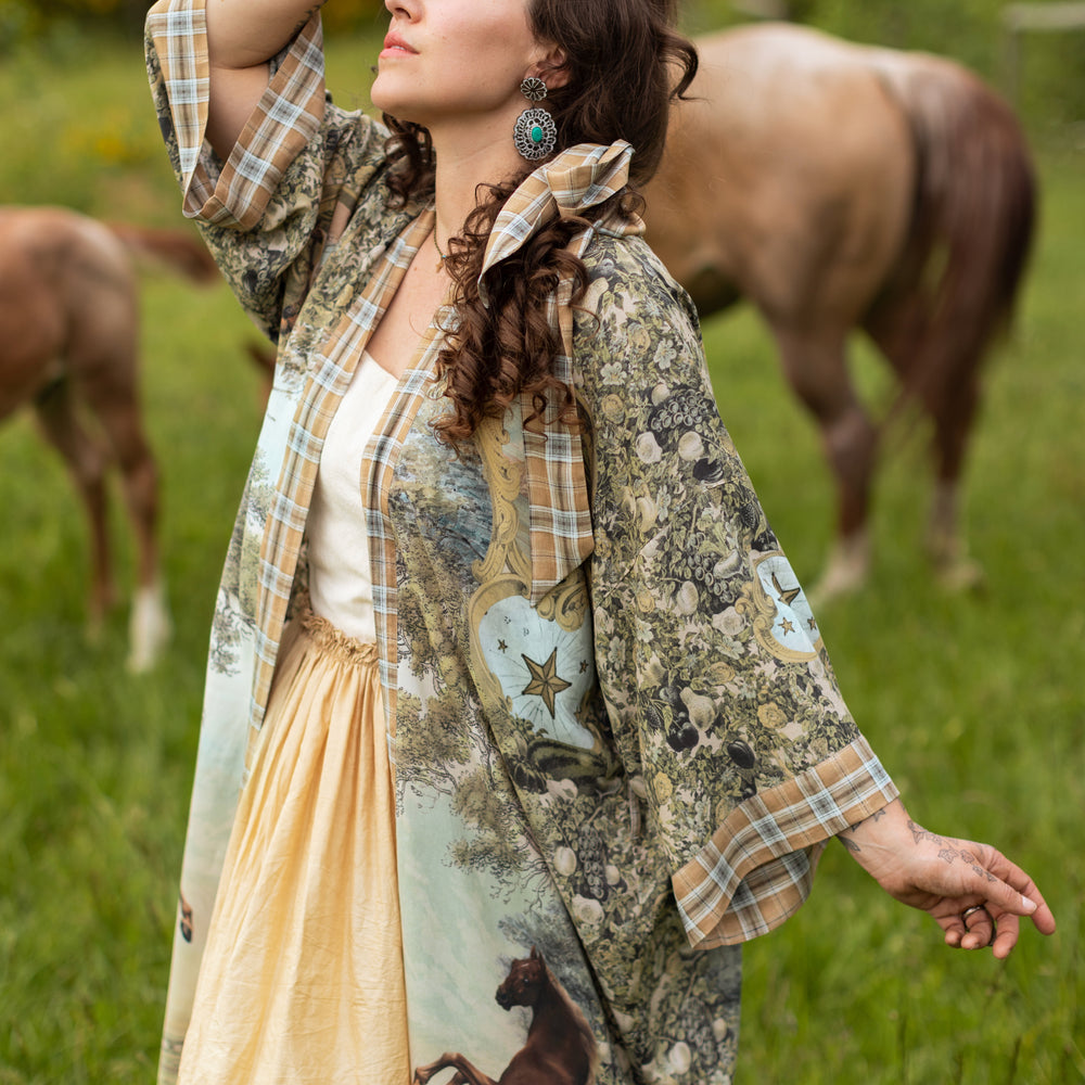 
                  
                    Model wearing a bamboo-viscose kimono duster robe made for everyday adventures with a whimsical print celebrating one's unbridled spirit of adventure - Market of Stars
                  
                