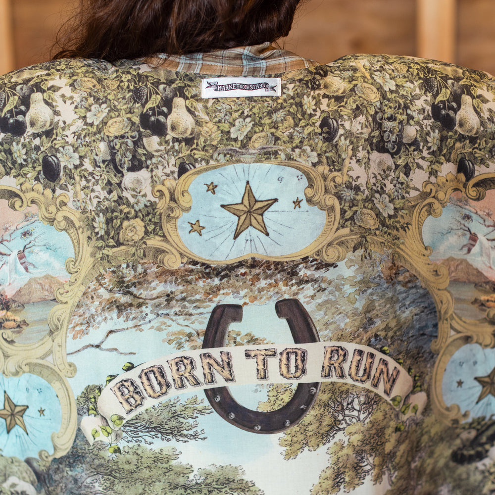 
                  
                    Model wearing a bamboo-viscose kimono duster robe made for everyday adventures with a whimsical print celebrating one's unbridled spirit of adventure - Market of Stars
                  
                