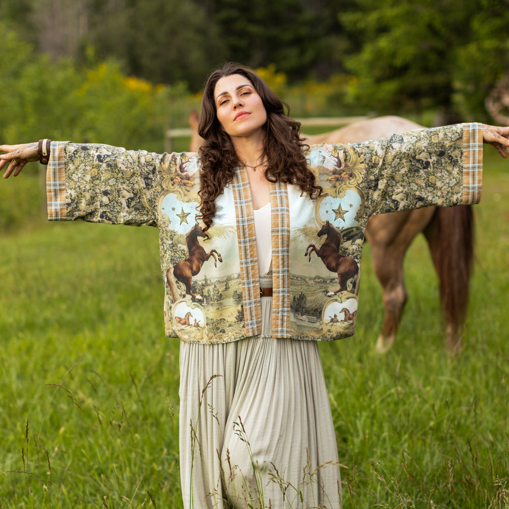
                  
                    Model wearing a bamboo-viscose cropped kimono duster made for everyday adventures with a whimsical print celebrating one's unbridled spirit of adventure - Market of Stars
                  
                