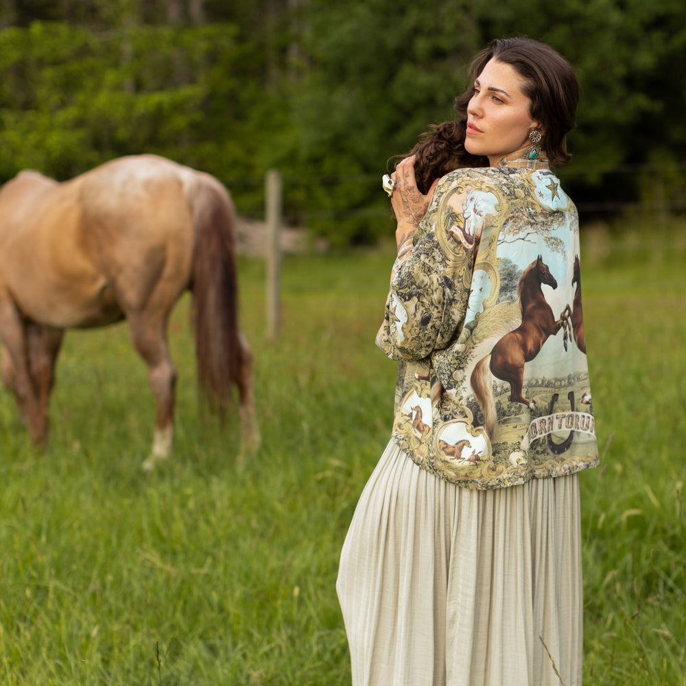 
                  
                    Model wearing a bamboo-viscose cropped kimono duster made for everyday adventures with a whimsical print celebrating one's unbridled spirit of adventure - Market of Stars
                  
                