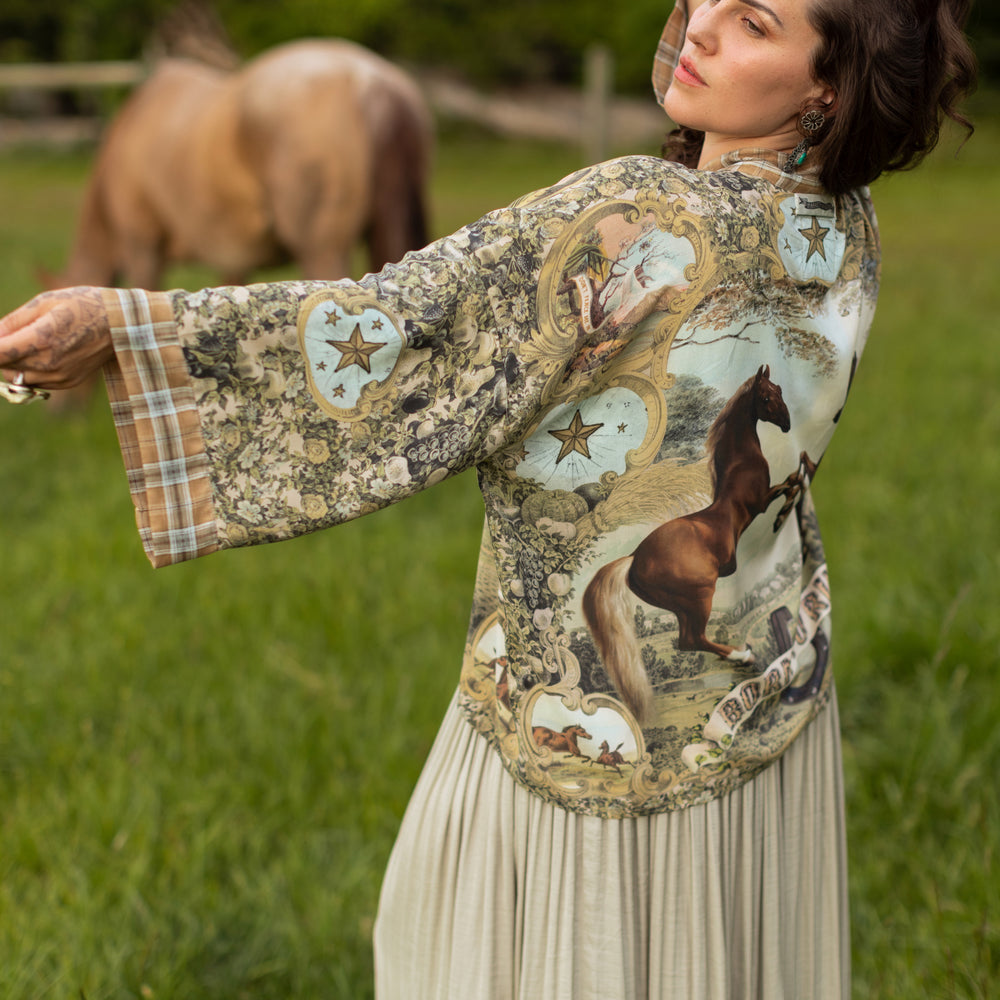 
                  
                    Model wearing a bamboo-viscose cropped kimono duster made for everyday adventures with a whimsical print celebrating one's unbridled spirit of adventure - Market of Stars
                  
                