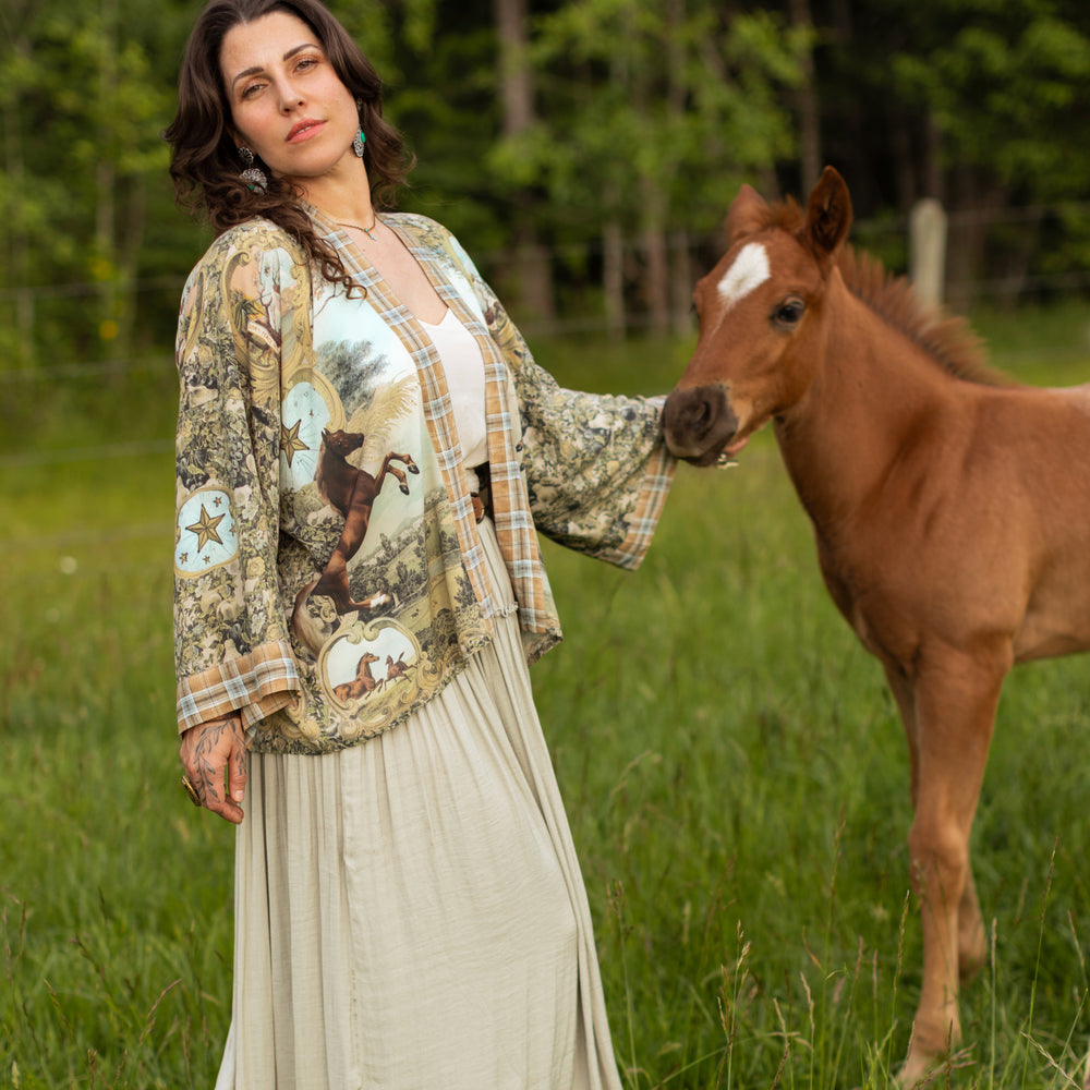 
                  
                    Model wearing a bamboo-viscose cropped kimono duster made for everyday adventures with a whimsical print celebrating one's unbridled spirit of adventure - Market of Stars
                  
                