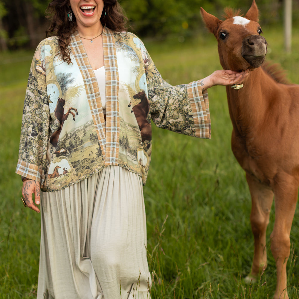 
                  
                    Model wearing a bamboo-viscose cropped kimono duster made for everyday adventures with a whimsical print celebrating one's unbridled spirit of adventure - Market of Stars
                  
                