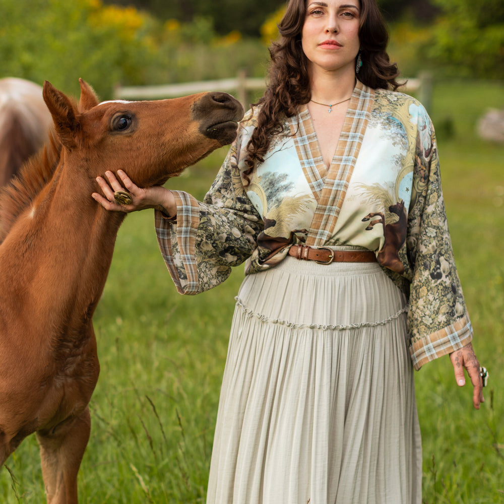 
                  
                    Model wearing a bamboo-viscose cropped kimono duster made for everyday adventures with a whimsical print celebrating one's unbridled spirit of adventure - Market of Stars
                  
                