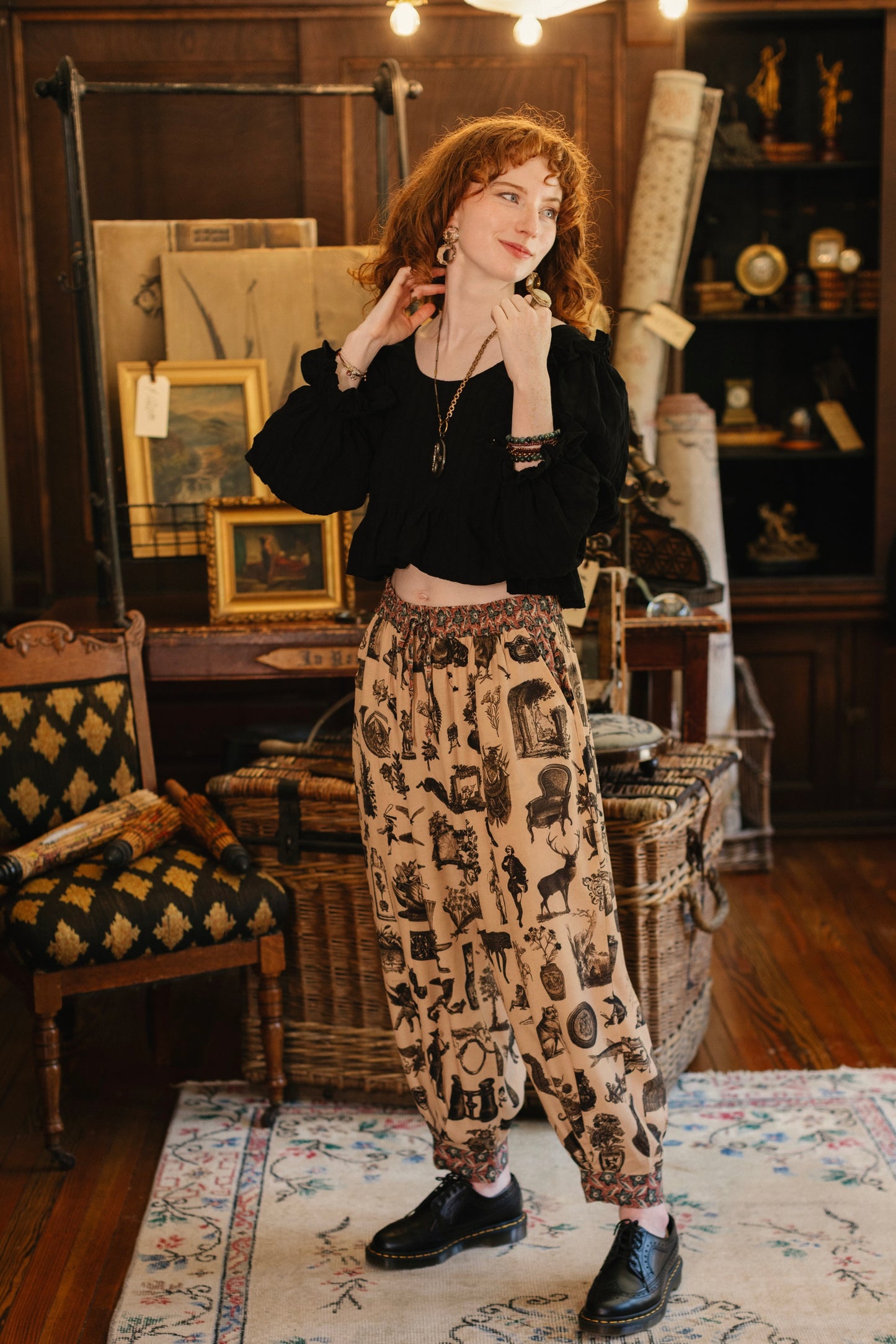 Model wearing relaxed viscose pant with elastic and drawstring waist, inspired by a mysterious Victorian scrapbook. This whimsical print celebrates the wonder hidden in ordinary things — Market of Stars.