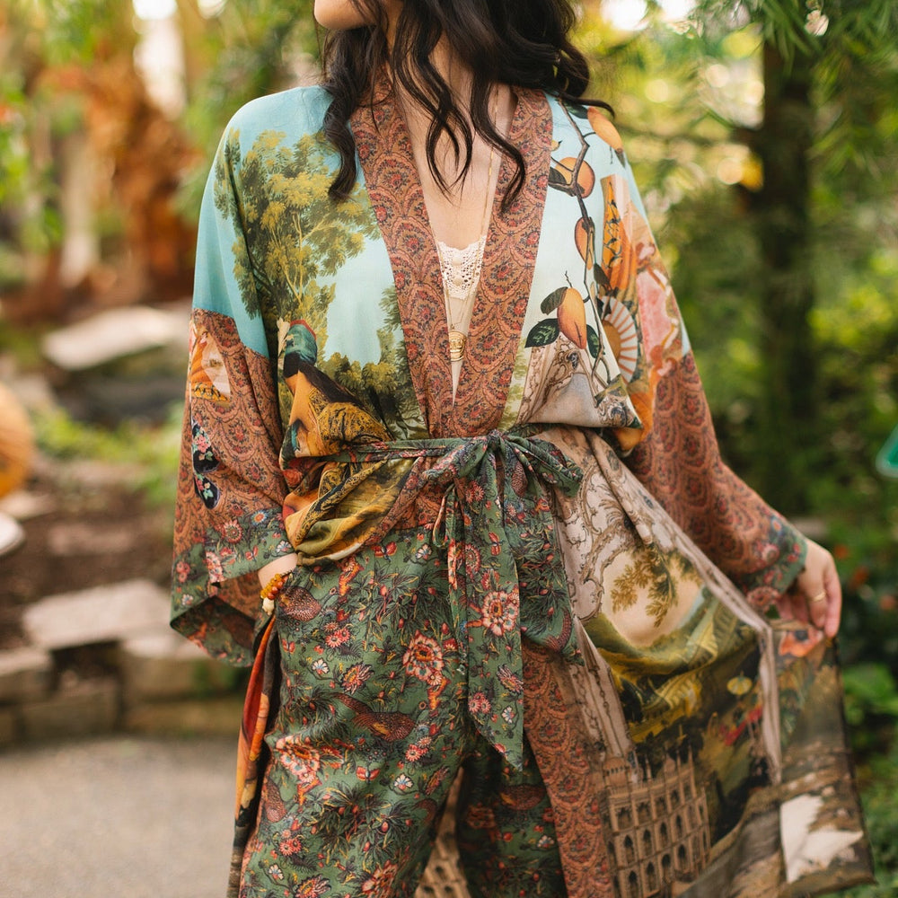 
                  
                    Model wearing Peace, Wine & Sunshine Bohéme Slip Dress featuring botanical collages and playful peace, wine and sunshine lettering on the hem – Market of Stars.
                  
                