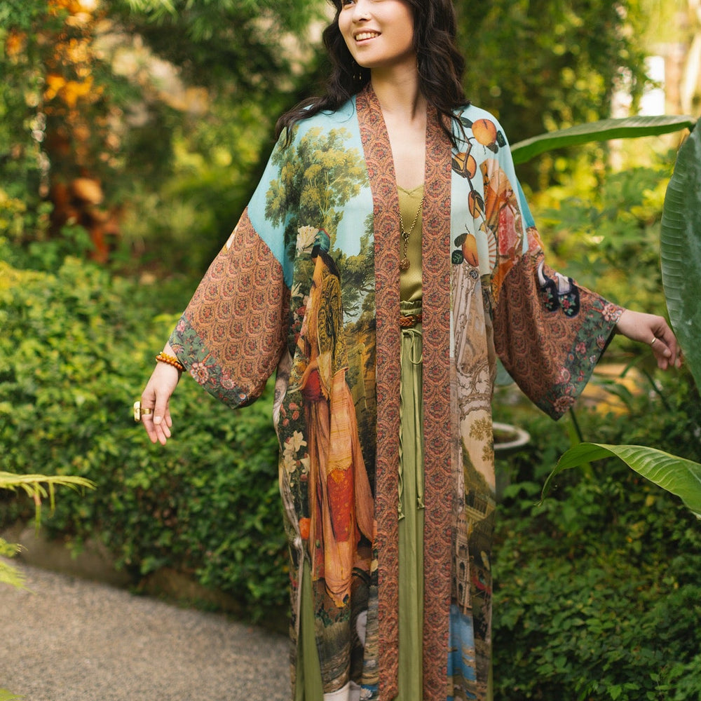 
                  
                    Model wearing Peace, Wine & Sunshine Bohéme Slip Dress featuring botanical collages and playful peace, wine and sunshine lettering on the hem – Market of Stars.
                  
                
