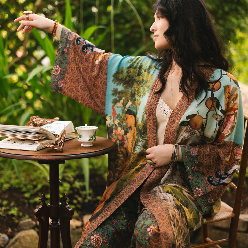 
                  
                    Model wearing Peace, Wine & Sunshine Bohéme Slip Dress featuring botanical collages and playful peace, wine and sunshine lettering on the hem – Market of Stars.
                  
                