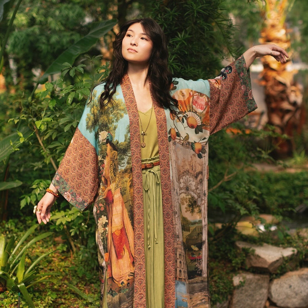 
                  
                    Model wearing Peace, Wine & Sunshine Bohéme Slip Dress featuring botanical collages and playful peace, wine and sunshine lettering on the hem – Market of Stars.
                  
                