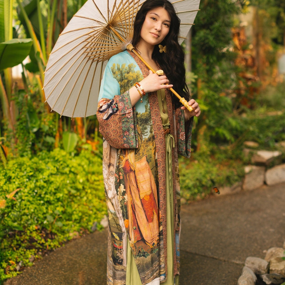 
                  
                    Model wearing Peace, Wine & Sunshine Bohéme Slip Dress featuring botanical collages and playful peace, wine and sunshine lettering on the hem – Market of Stars.
                  
                