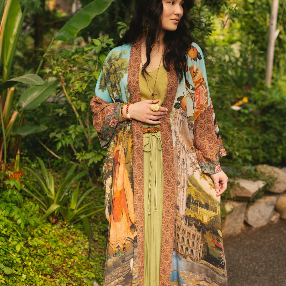 
                  
                    Model wearing Peace, Wine & Sunshine Bohéme Slip Dress featuring botanical collages and playful peace, wine and sunshine lettering on the hem – Market of Stars.
                  
                