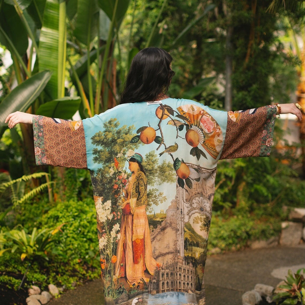 
                  
                    Model wearing Peace, Wine & Sunshine Bohéme Slip Dress featuring botanical collages and playful peace, wine and sunshine lettering on the hem – Market of Stars.
                  
                