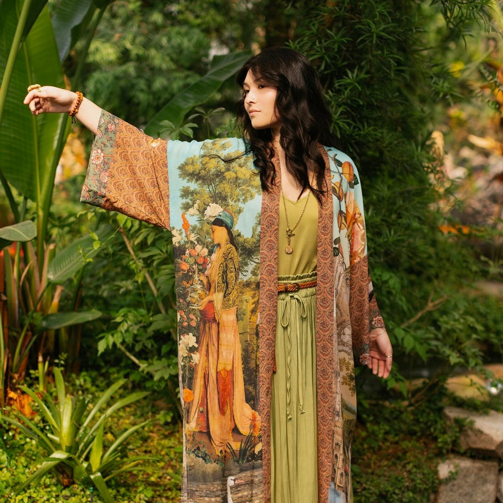 
                  
                    Model wearing Peace, Wine & Sunshine Bohéme Slip Dress featuring botanical collages and playful peace, wine and sunshine lettering on the hem – Market of Stars.
                  
                