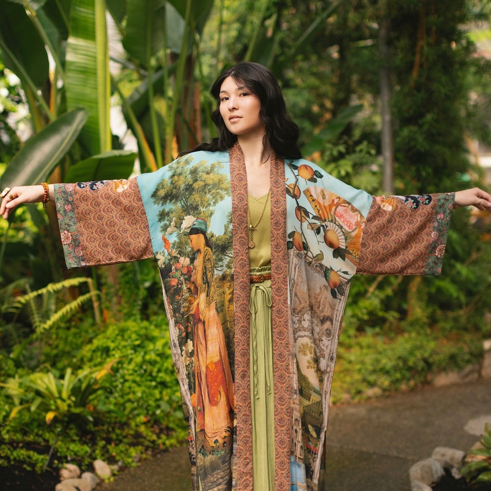 
                  
                    Model wearing Peace, Wine & Sunshine Bohéme Slip Dress featuring botanical collages and playful peace, wine and sunshine lettering on the hem – Market of Stars.
                  
                