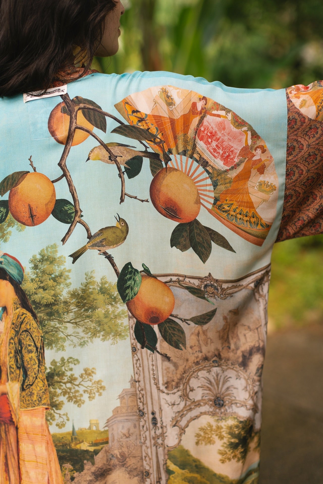 Model wearing Peace, Wine & Sunshine Bohéme Slip Dress featuring botanical collages and playful peace, wine and sunshine lettering on the hem – Market of Stars.