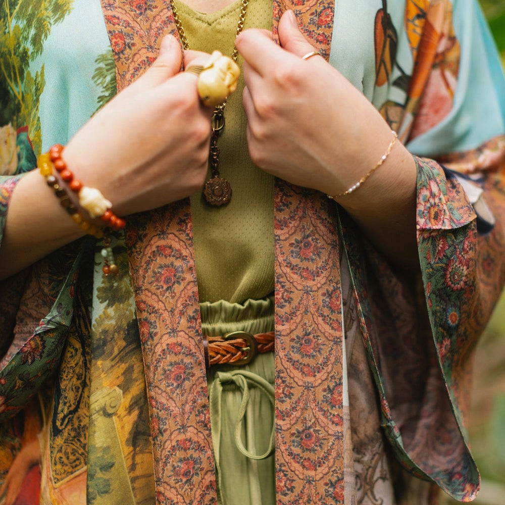 
                  
                    Model wearing Peace, Wine & Sunshine Bohéme Slip Dress featuring botanical collages and playful peace, wine and sunshine lettering on the hem – Market of Stars.
                  
                