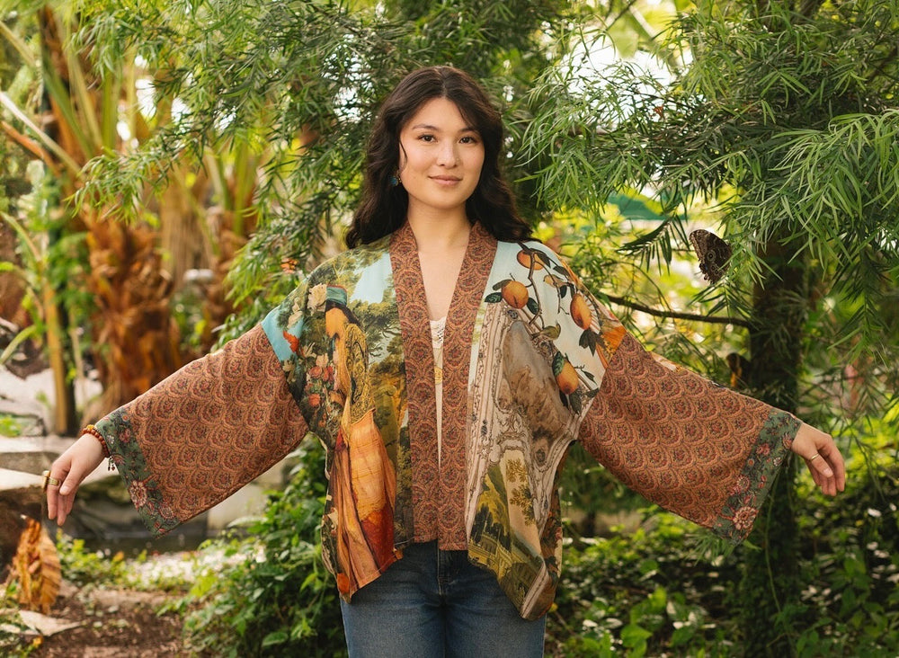 
                  
                    Model wearing Peace, Wine & Sunshine Bohéme Slip Dress featuring botanical collages and playful peace, wine and sunshine lettering on the hem – Market of Stars.
                  
                