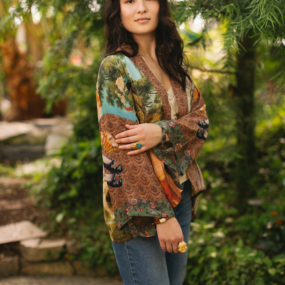 
                  
                    Model wearing Peace, Wine & Sunshine Bohéme Slip Dress featuring botanical collages and playful peace, wine and sunshine lettering on the hem – Market of Stars.
                  
                