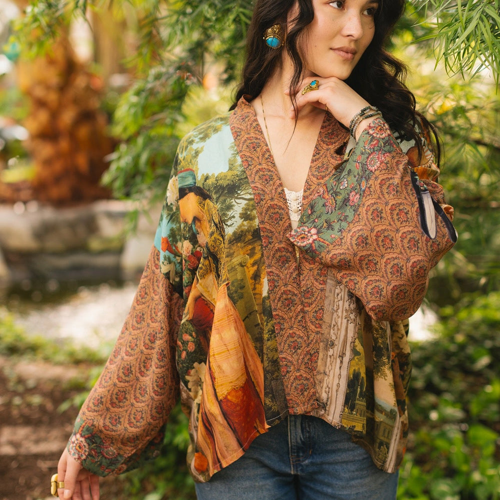 
                  
                    Model wearing Peace, Wine & Sunshine Bohéme Slip Dress featuring botanical collages and playful peace, wine and sunshine lettering on the hem – Market of Stars.
                  
                