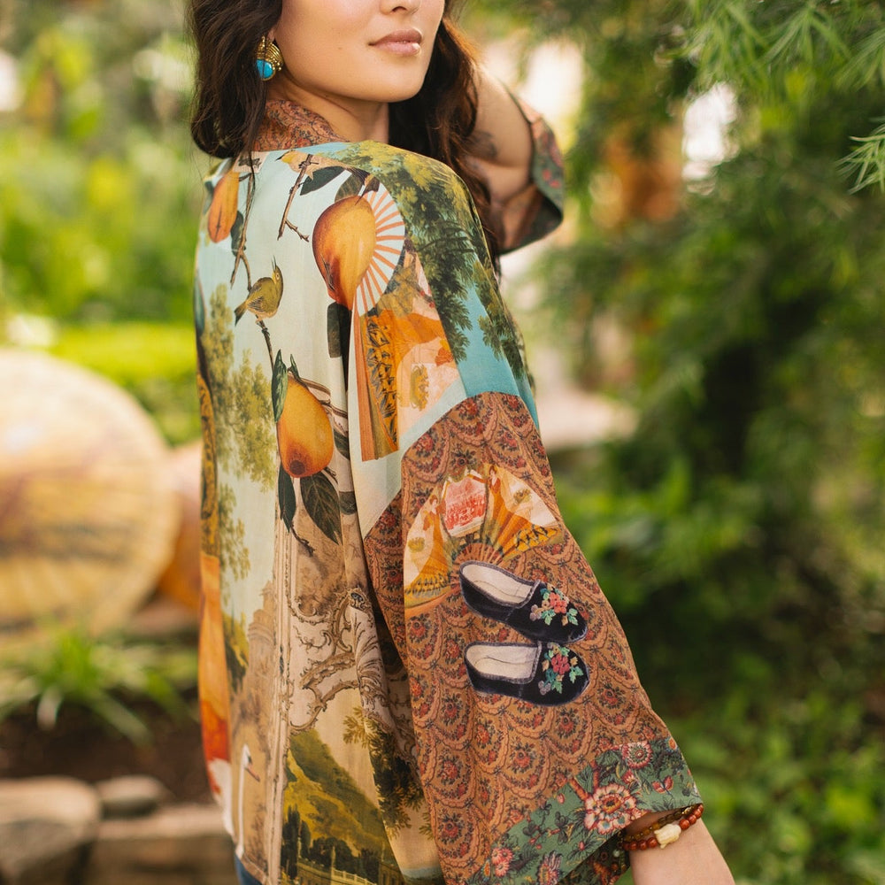 
                  
                    Model wearing Peace, Wine & Sunshine Bohéme Slip Dress featuring botanical collages and playful peace, wine and sunshine lettering on the hem – Market of Stars.
                  
                