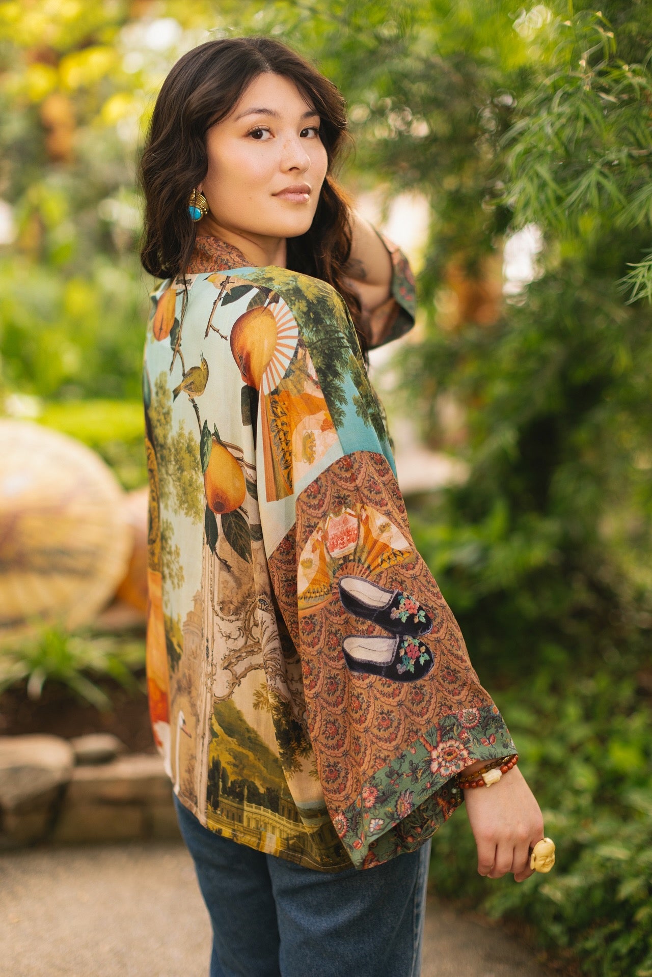 Model wearing Peace, Wine & Sunshine Bohéme Slip Dress featuring botanical collages and playful peace, wine and sunshine lettering on the hem – Market of Stars.