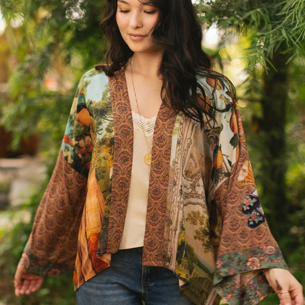 
                  
                    Model wearing Peace, Wine & Sunshine Bohéme Slip Dress featuring botanical collages and playful peace, wine and sunshine lettering on the hem – Market of Stars.
                  
                