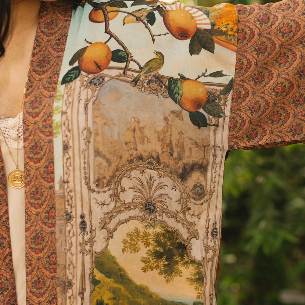 
                  
                    Model wearing Peace, Wine & Sunshine Bohéme Slip Dress featuring botanical collages and playful peace, wine and sunshine lettering on the hem – Market of Stars.
                  
                