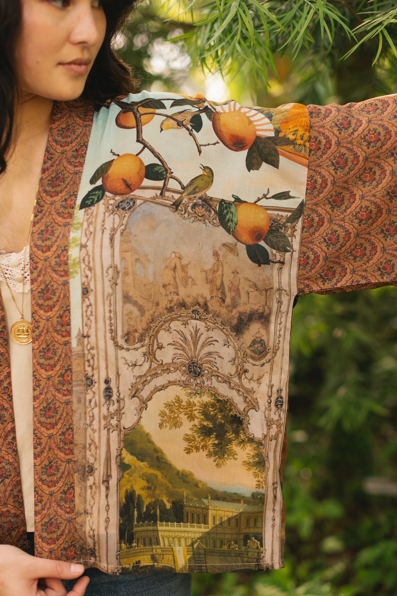Model wearing Peace, Wine & Sunshine Bohéme Slip Dress featuring botanical collages and playful peace, wine and sunshine lettering on the hem – Market of Stars.