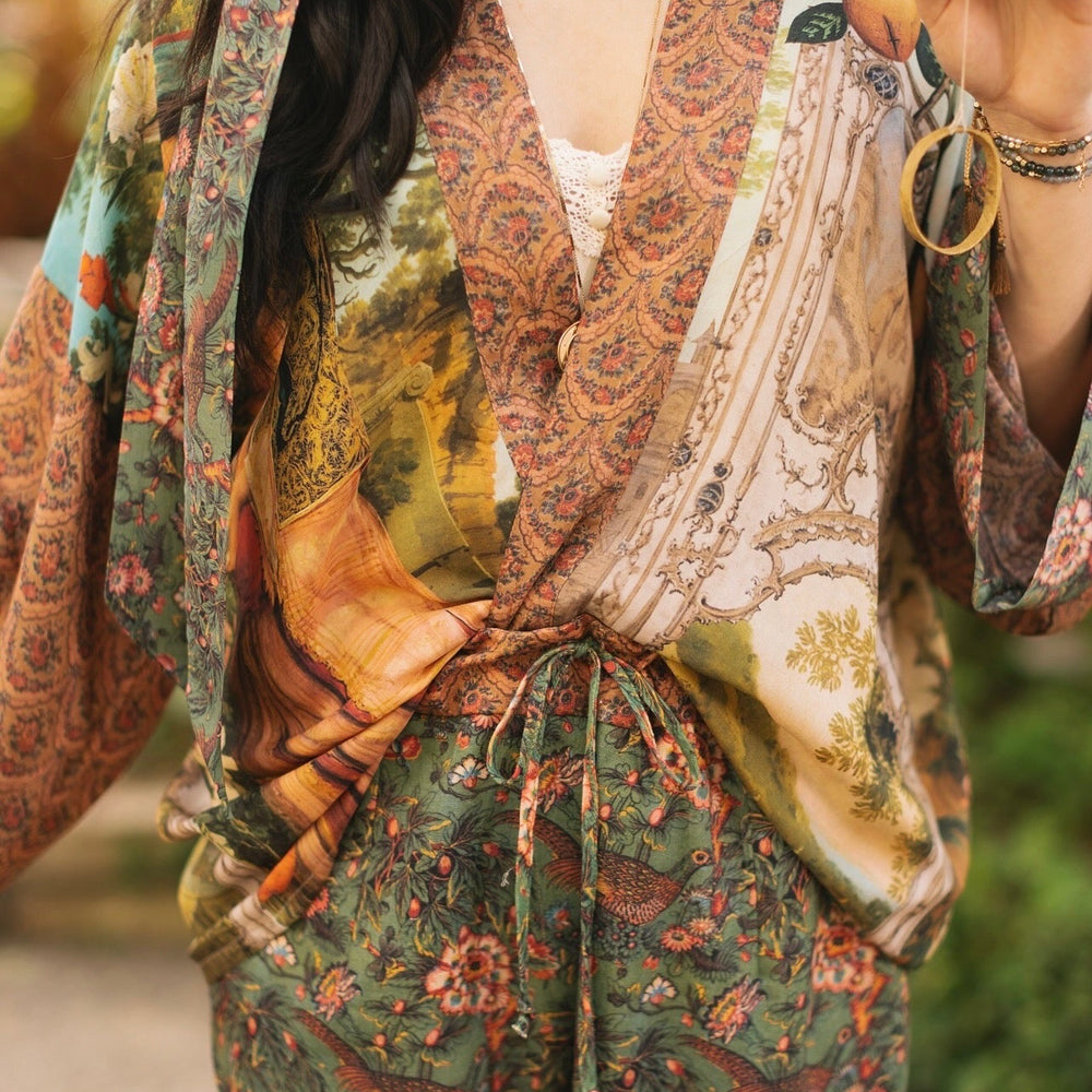 
                  
                    Model wearing Peace, Wine & Sunshine Bohéme Slip Dress featuring botanical collages and playful peace, wine and sunshine lettering on the hem – Market of Stars.
                  
                