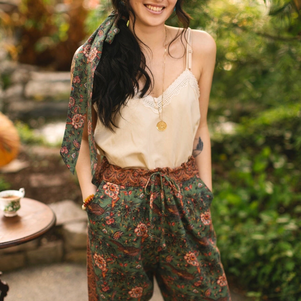 
                  
                    Model wearing Peace, Wine & Sunshine Bohéme Slip Dress featuring botanical collages and playful peace, wine and sunshine lettering on the hem – Market of Stars.
                  
                