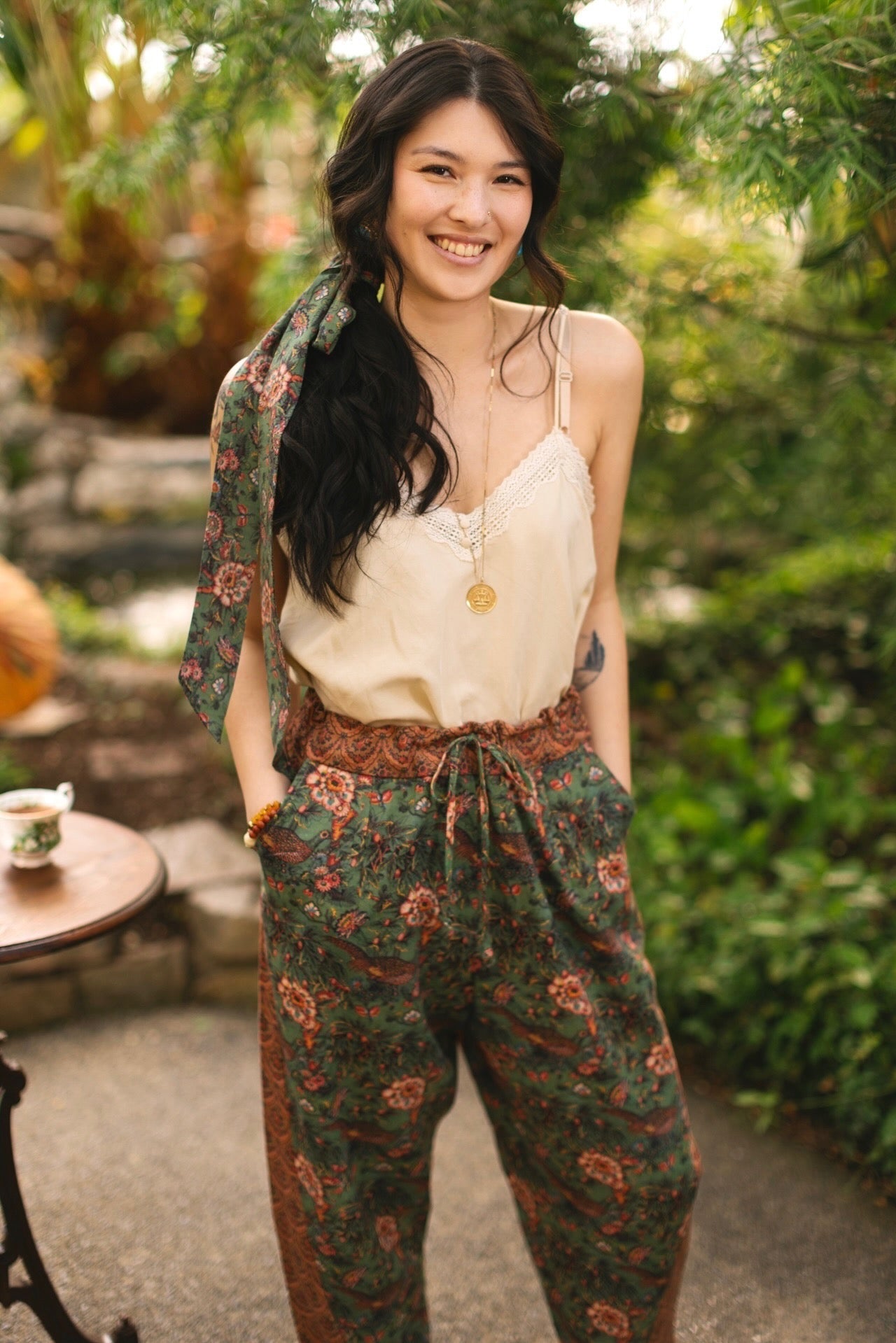 Model wearing Peace, Wine & Sunshine Bohéme Slip Dress featuring botanical collages and playful peace, wine and sunshine lettering on the hem – Market of Stars.