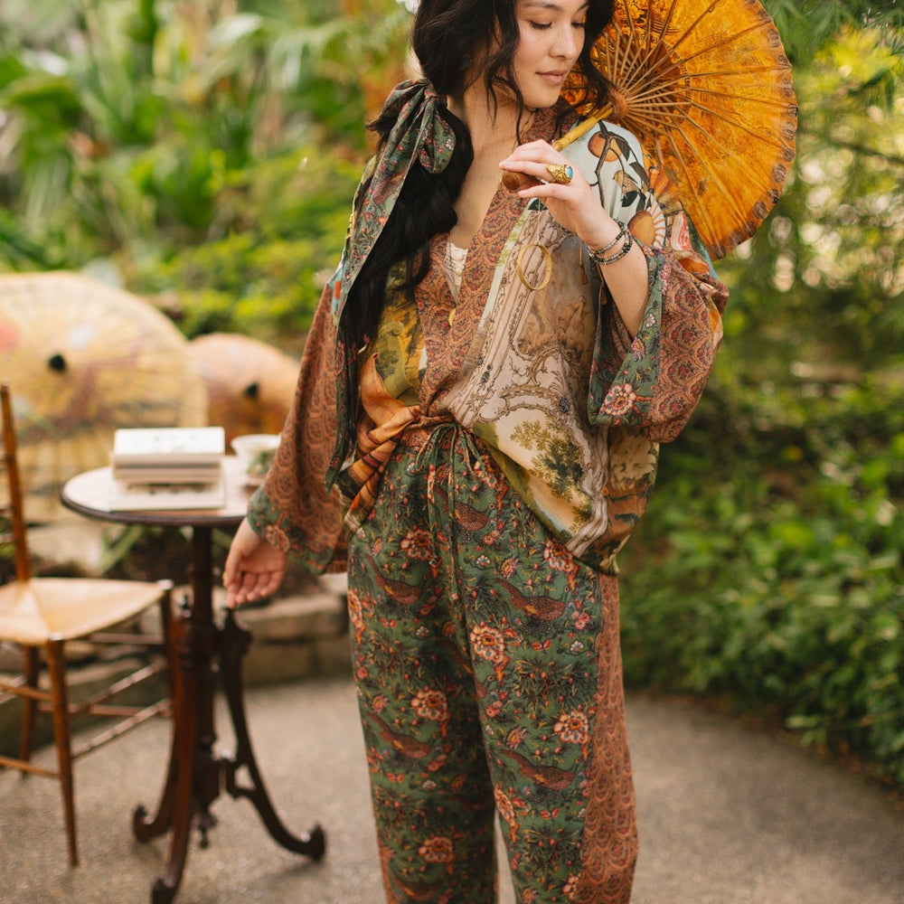 
                  
                    Model wearing Peace, Wine & Sunshine Bohéme Slip Dress featuring botanical collages and playful peace, wine and sunshine lettering on the hem – Market of Stars.
                  
                