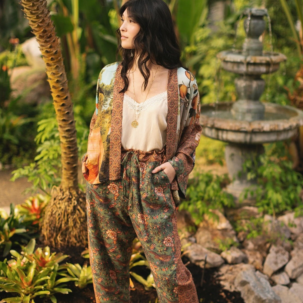
                  
                    Model wearing Peace, Wine & Sunshine Bohéme Slip Dress featuring botanical collages and playful peace, wine and sunshine lettering on the hem – Market of Stars.
                  
                
