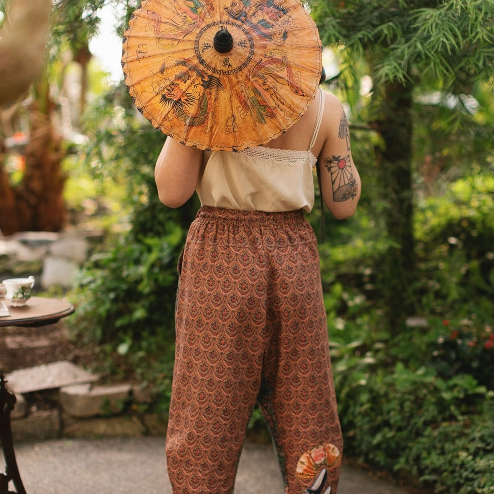 
                  
                    Model wearing Peace, Wine & Sunshine Bohéme Slip Dress featuring botanical collages and playful peace, wine and sunshine lettering on the hem – Market of Stars.
                  
                