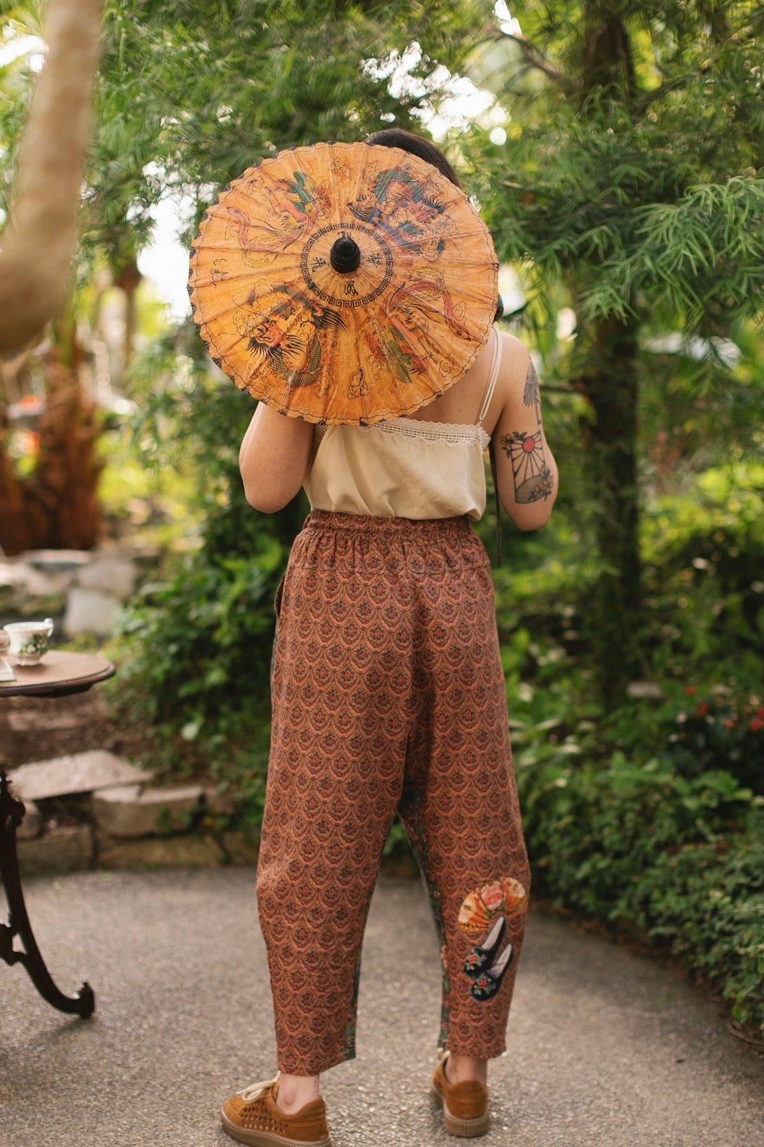 Model wearing Peace, Wine & Sunshine Bohéme Slip Dress featuring botanical collages and playful peace, wine and sunshine lettering on the hem – Market of Stars.