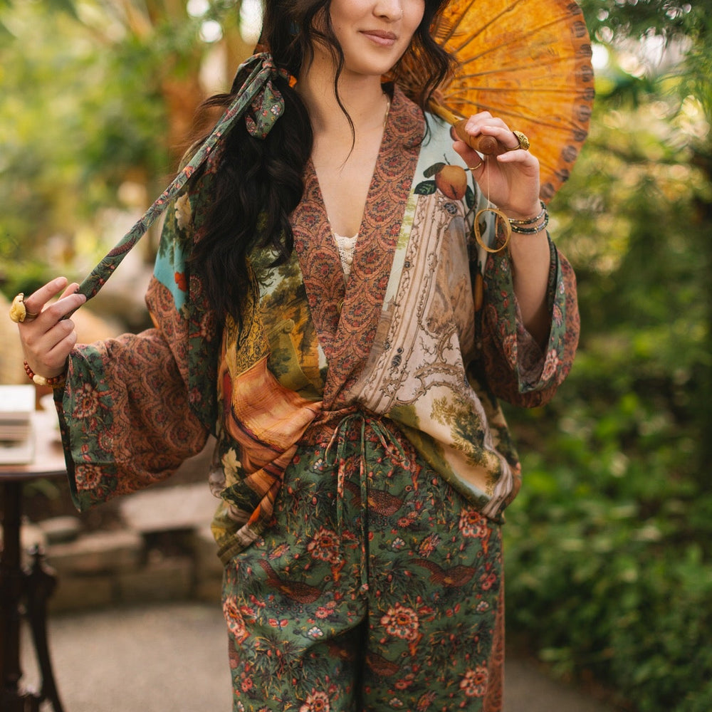 
                  
                    Model wearing Peace, Wine & Sunshine Bohéme Slip Dress featuring botanical collages and playful peace, wine and sunshine lettering on the hem – Market of Stars.
                  
                