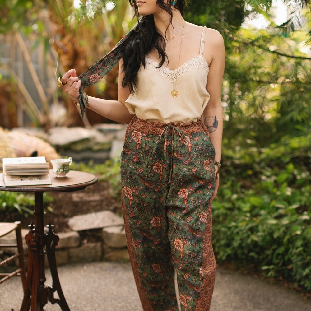
                  
                    Model wearing Peace, Wine & Sunshine Bohéme Slip Dress featuring botanical collages and playful peace, wine and sunshine lettering on the hem – Market of Stars.
                  
                